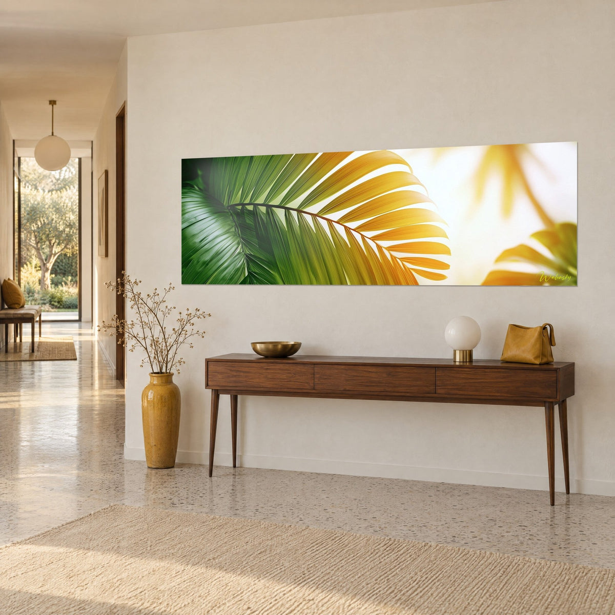 Wall art panoramic tropical palm leaf, green and honey-yellow leaflets against a sunlit white background, above a wooden console