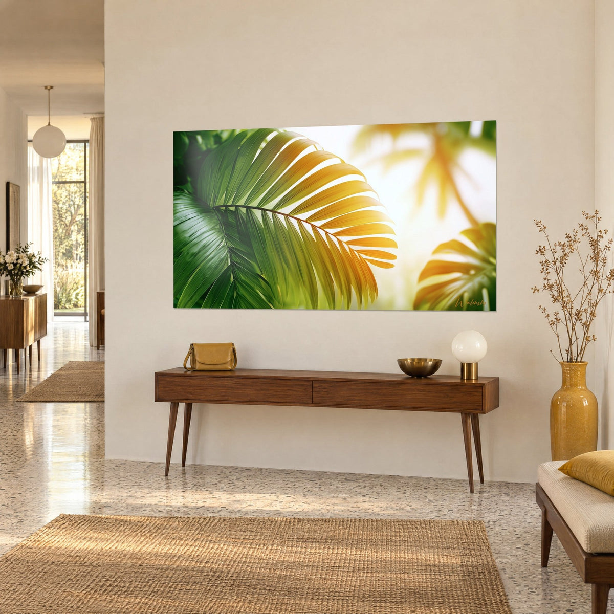 Wall art palm frond with golden and deep green leaflets, blurred silhouettes in the background, on a beige hallway wall