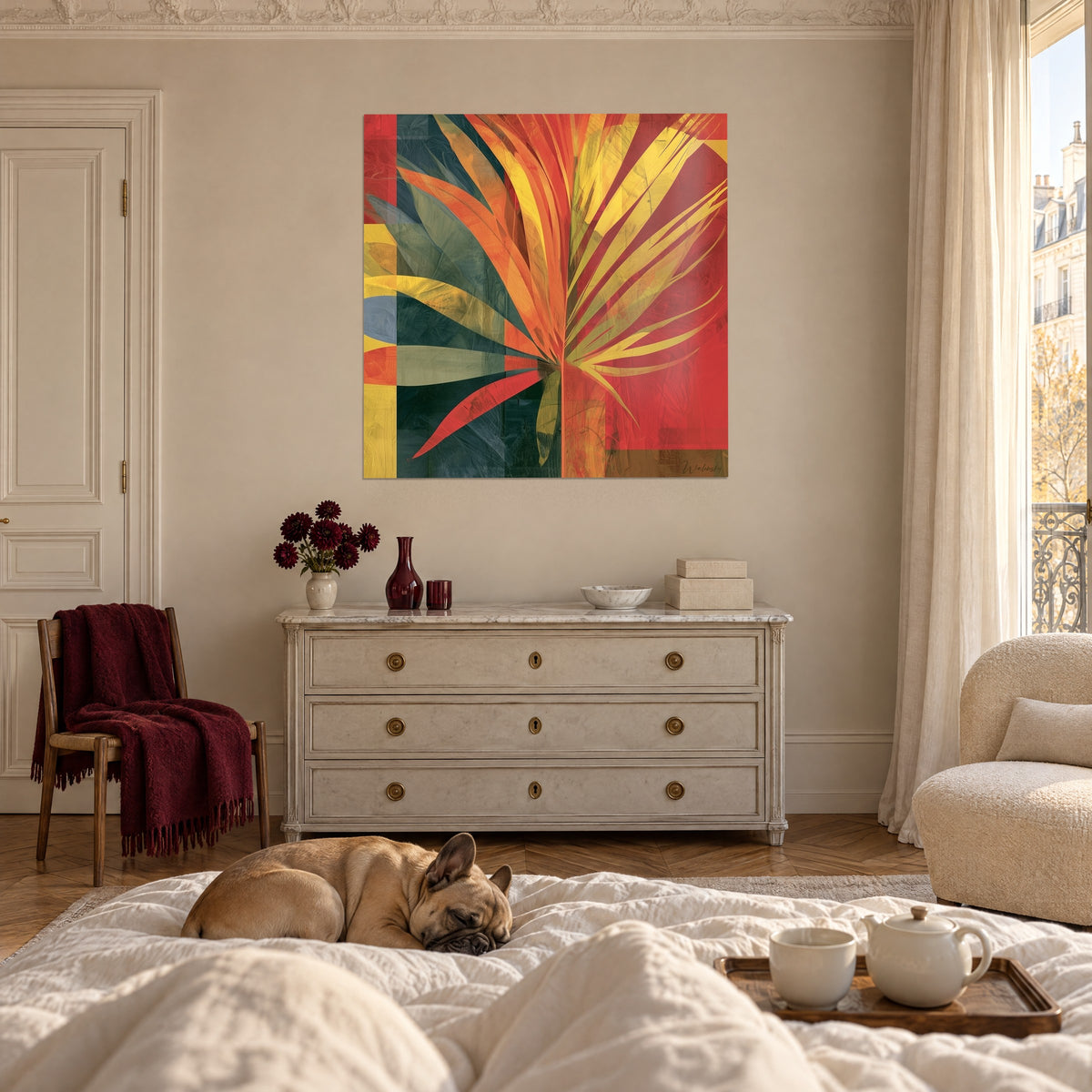 Wall art sheaf of sun-like leaves in orange and yellow on deep red, above a bed in a bright bedroom