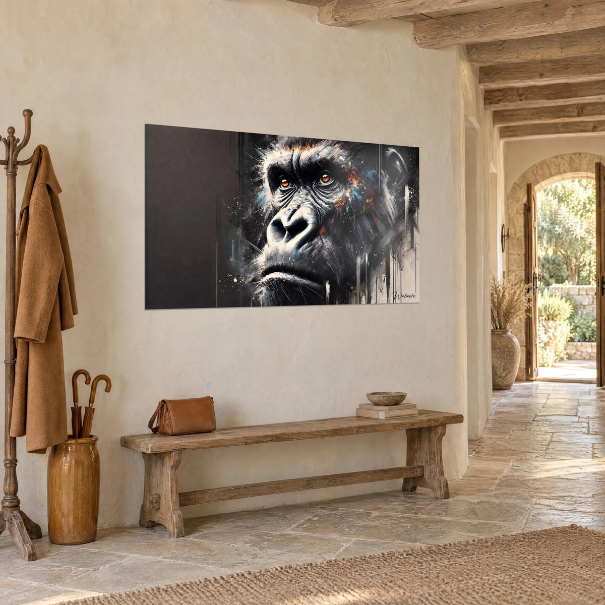 Wall art primate portrait with an orange-tinted gaze, matte brown background and white drips, seen three-quarter view in a stone entrance hall