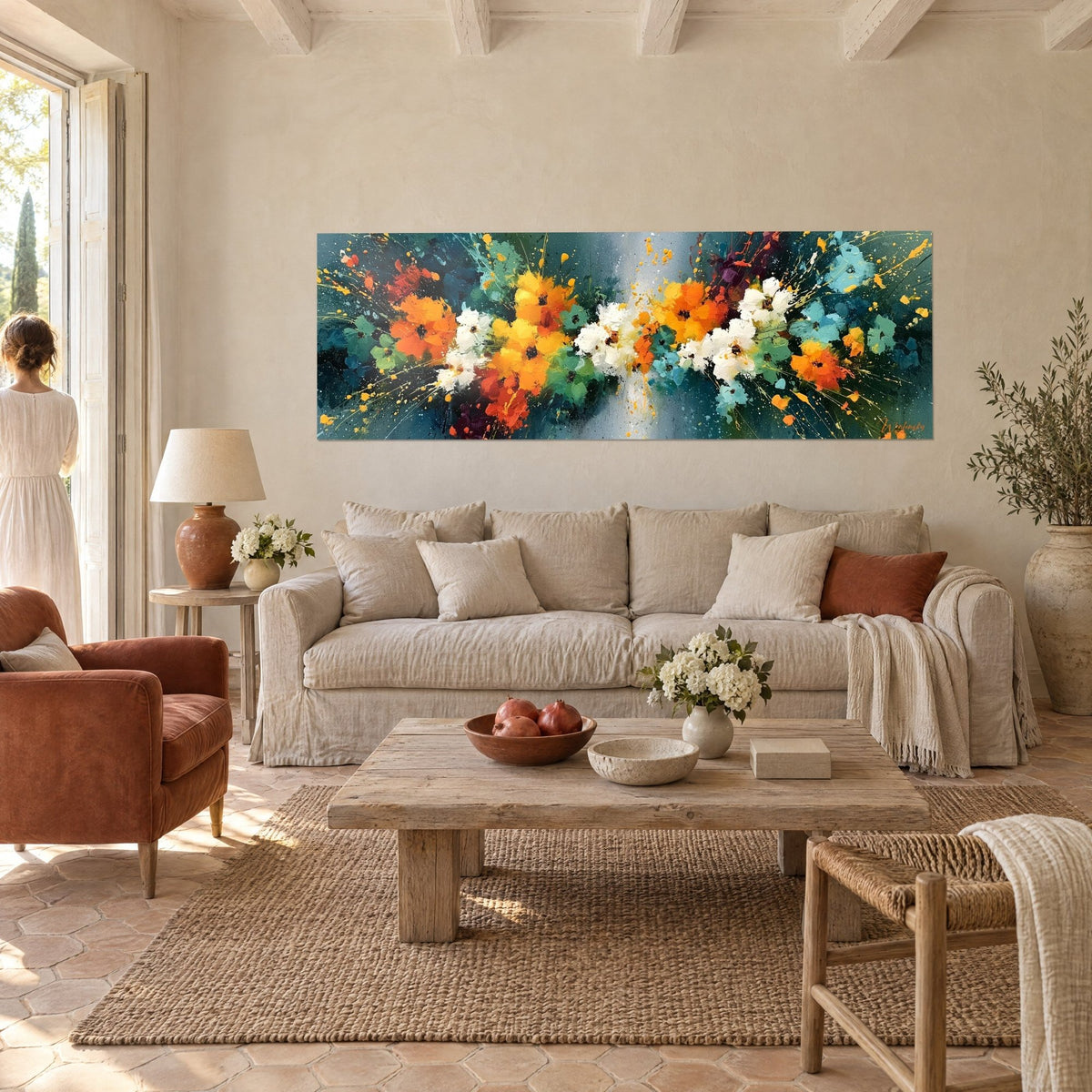 Wall art bouquet of orange and white petals splashed with yellow on a teal background, above a sofa in a bright living room
