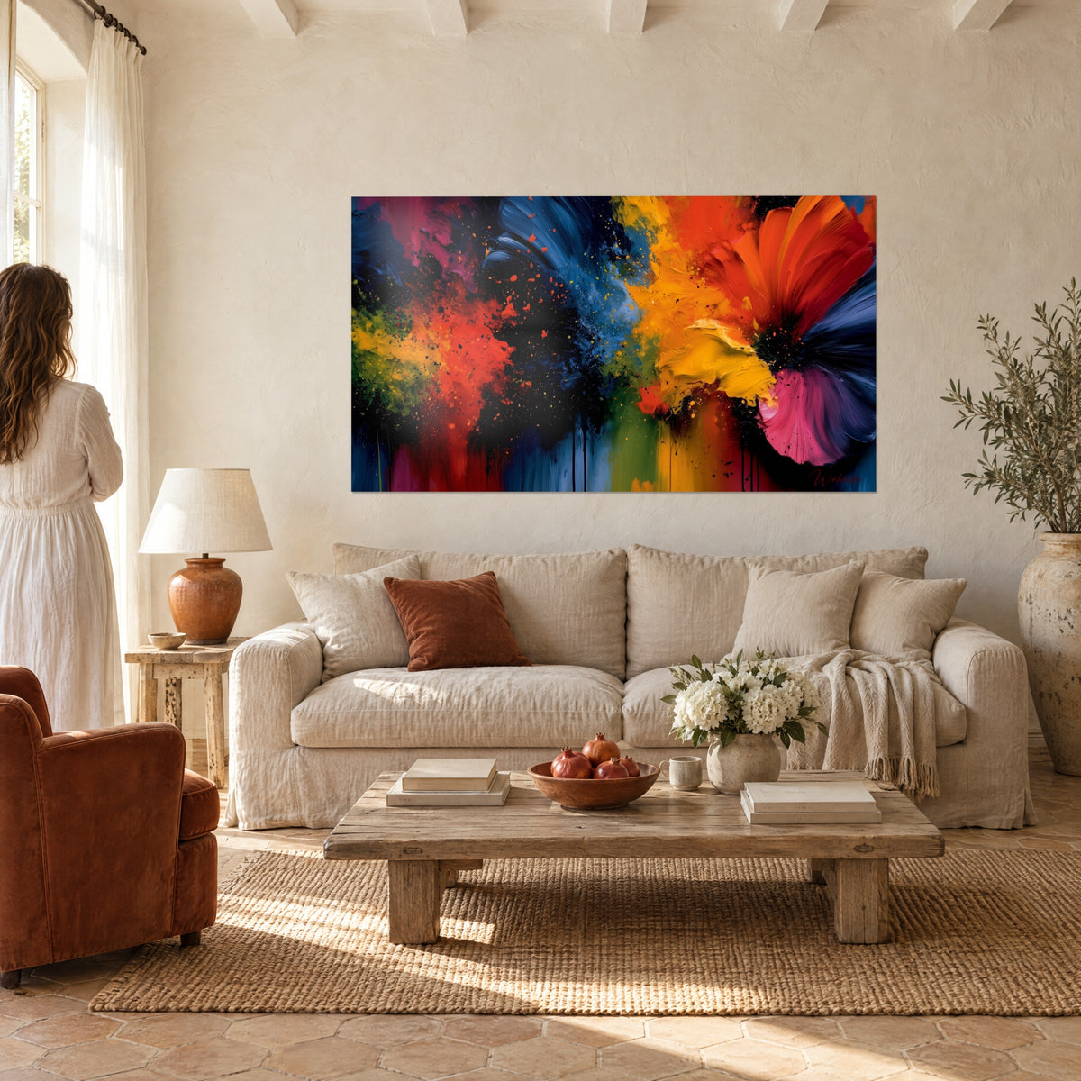 Wall art paint explosion in orange and navy blue, pink corolla on the right, above a sofa in a bright living room