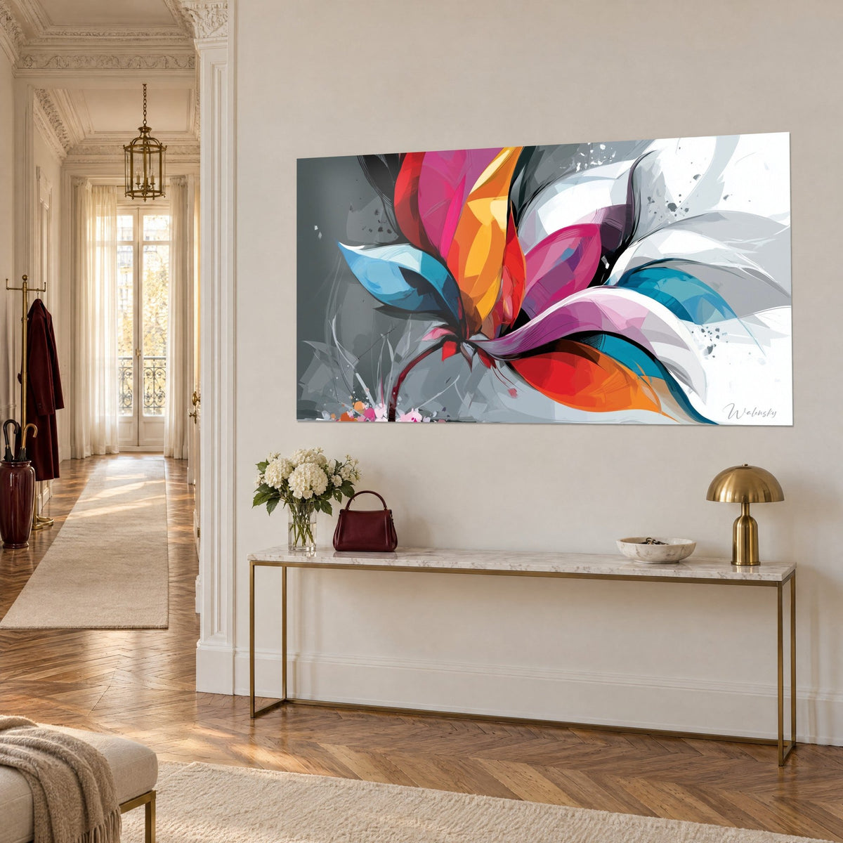 Wall art geometric flower head in bold red, yellow and pink on anthracite grey background, above a gilded console, three-quarter view