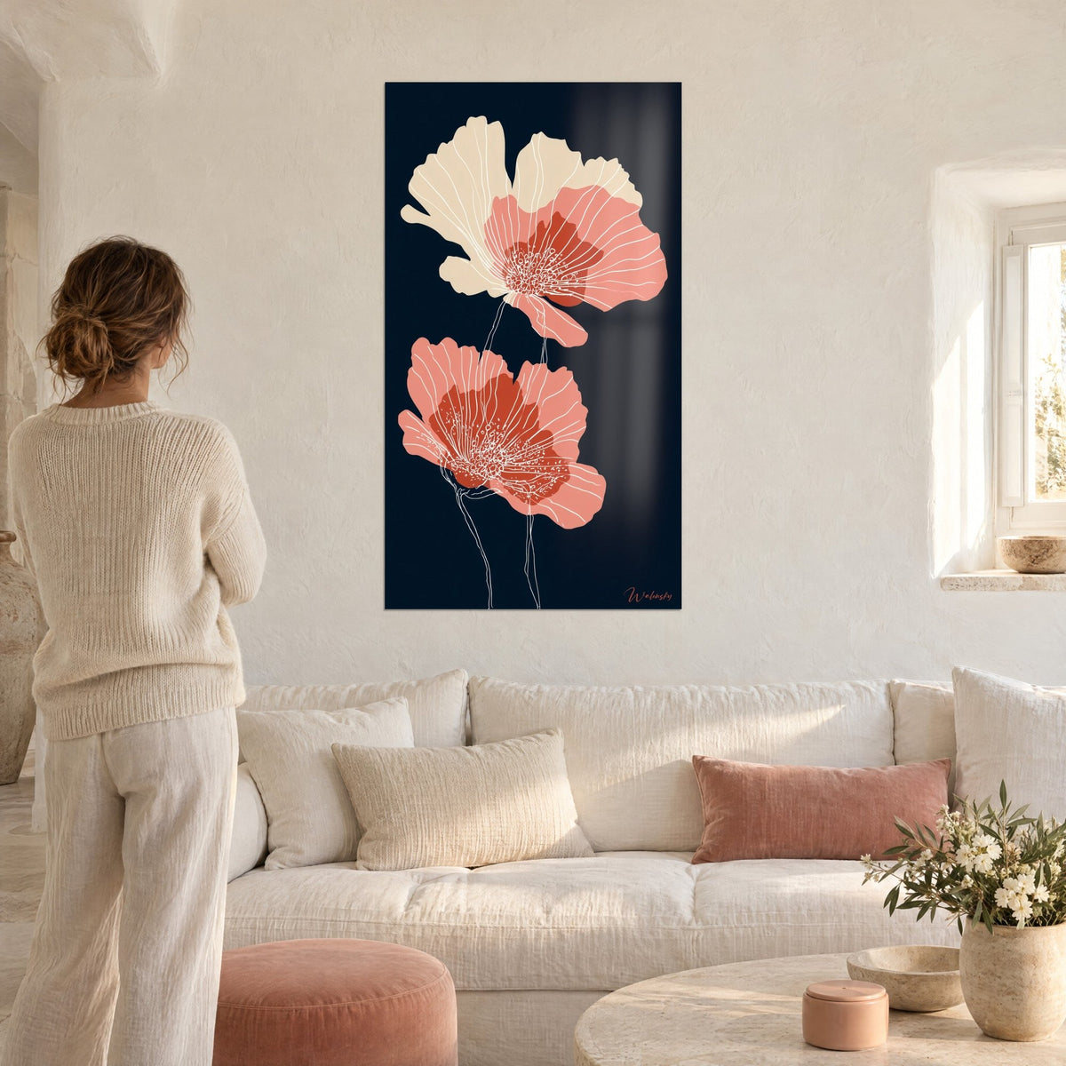 Wall art coral and ivory poppies with white veining on a midnight blue background, above a sofa in a bright living room