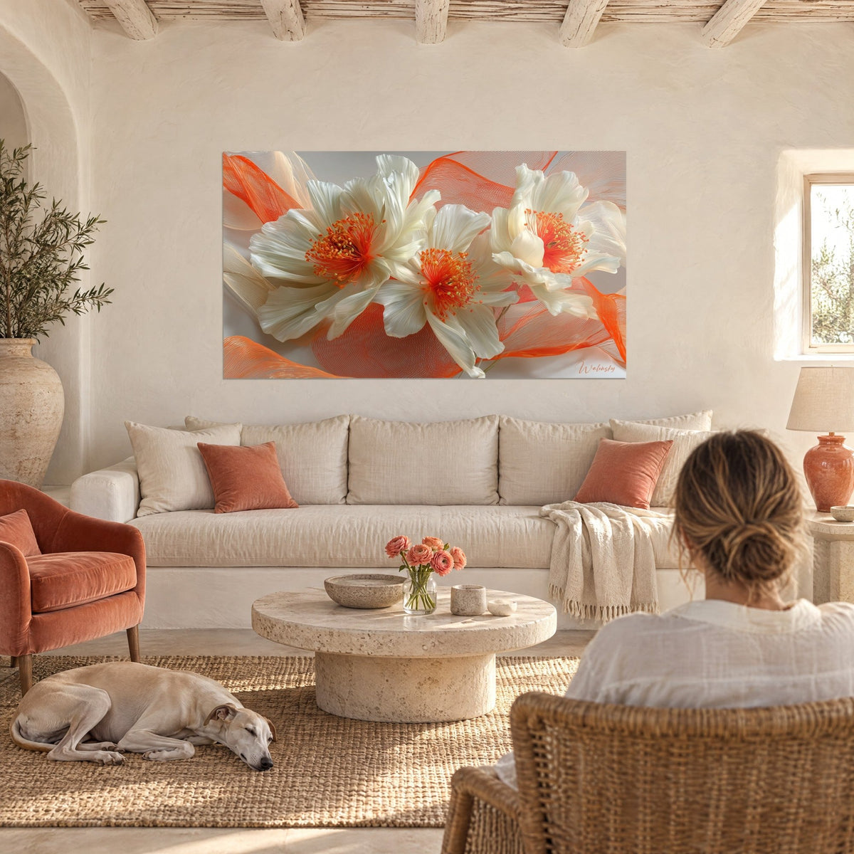 Wall art white peonies with bright orange stamens and coral red veils, above a sofa in a bright living room