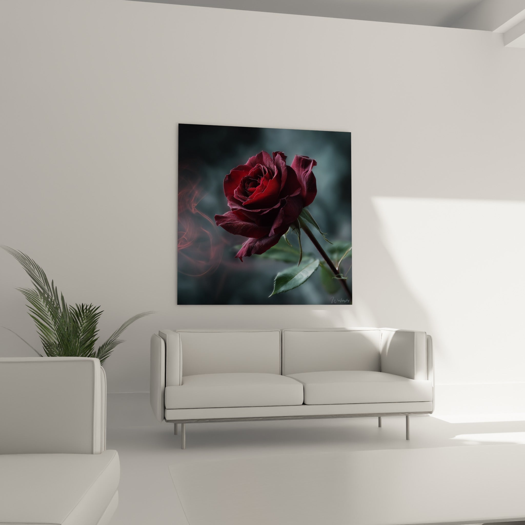 Pétales rouge sombre et feuillage vert émeraude accrochés au-dessus d'un canapé dans un salon lumineux