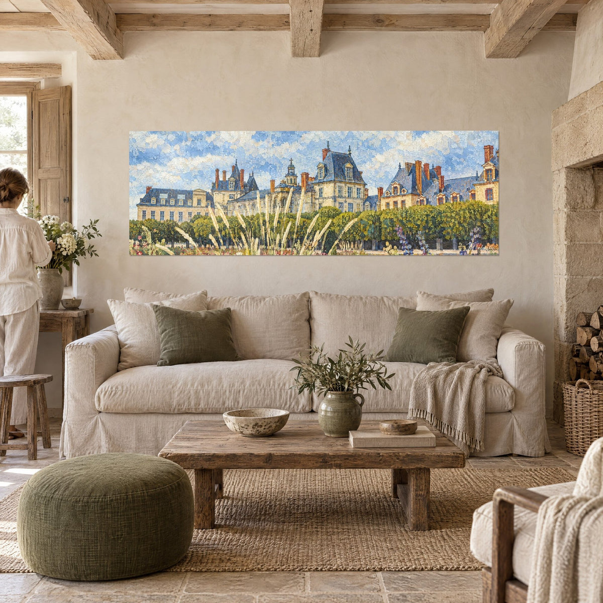 Gemälde Schloss aus beigem Stein und blauem Schiefer, blonde Gräser im Vordergrund, über einem Sofa in einem hellen Wohnzimmer
