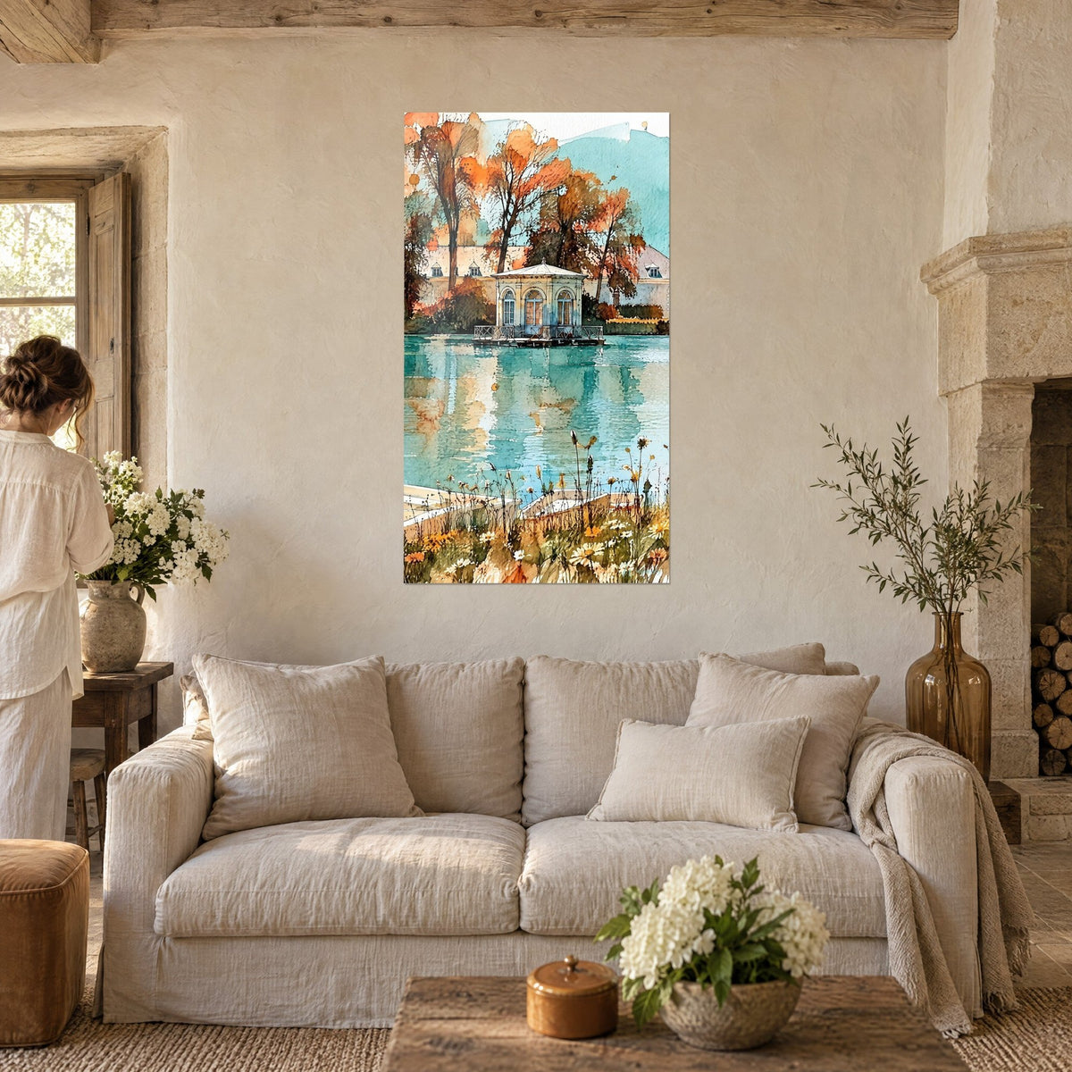 Wall art octagonal pavilion on the pond, turquoise and orange reflections, red maples; a woman seen from behind, above a sofa in a bright living room