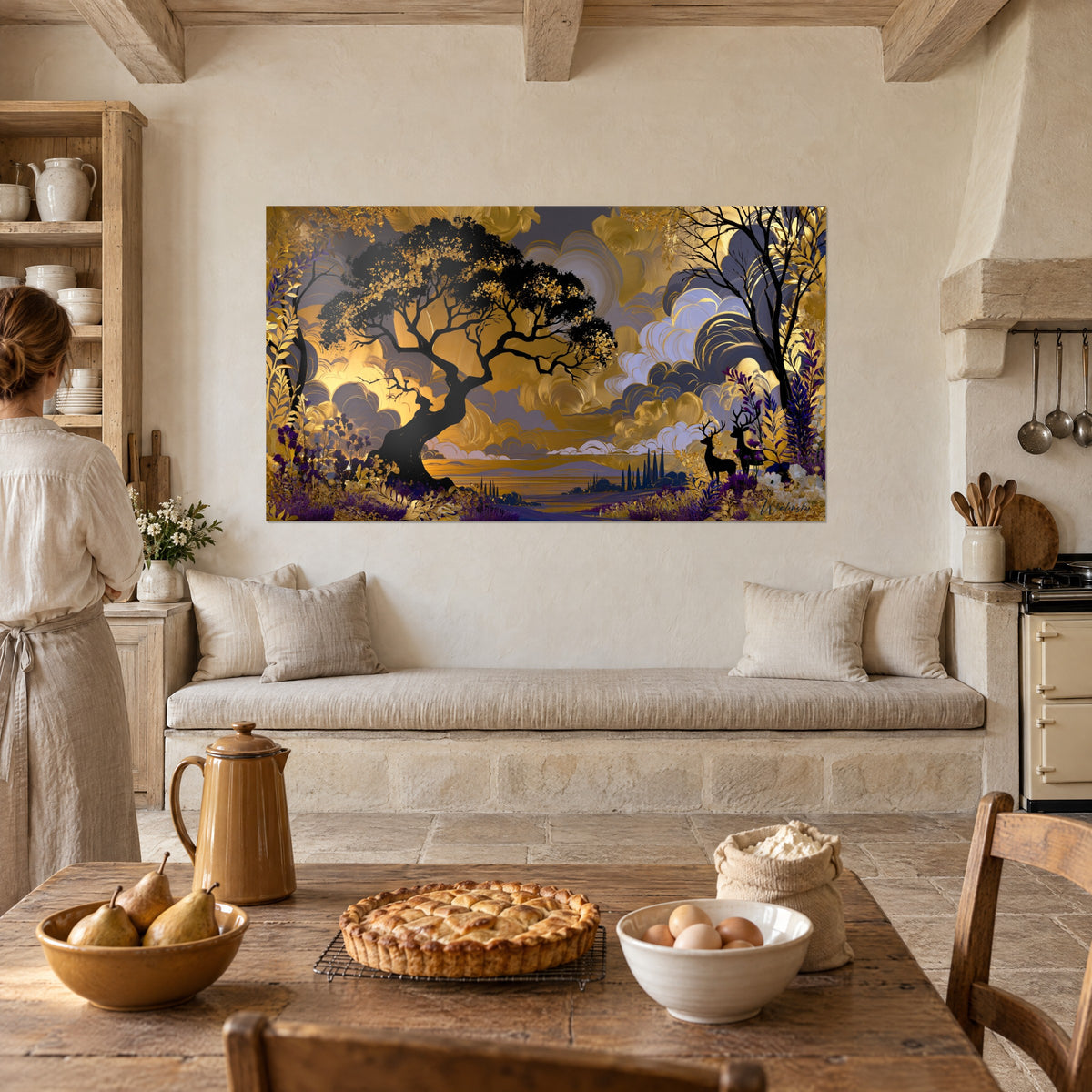 Wall art of a sinuous tree silhouette against a brushed golden sky, purple shrubs, two deer, near a rustic stone kitchen