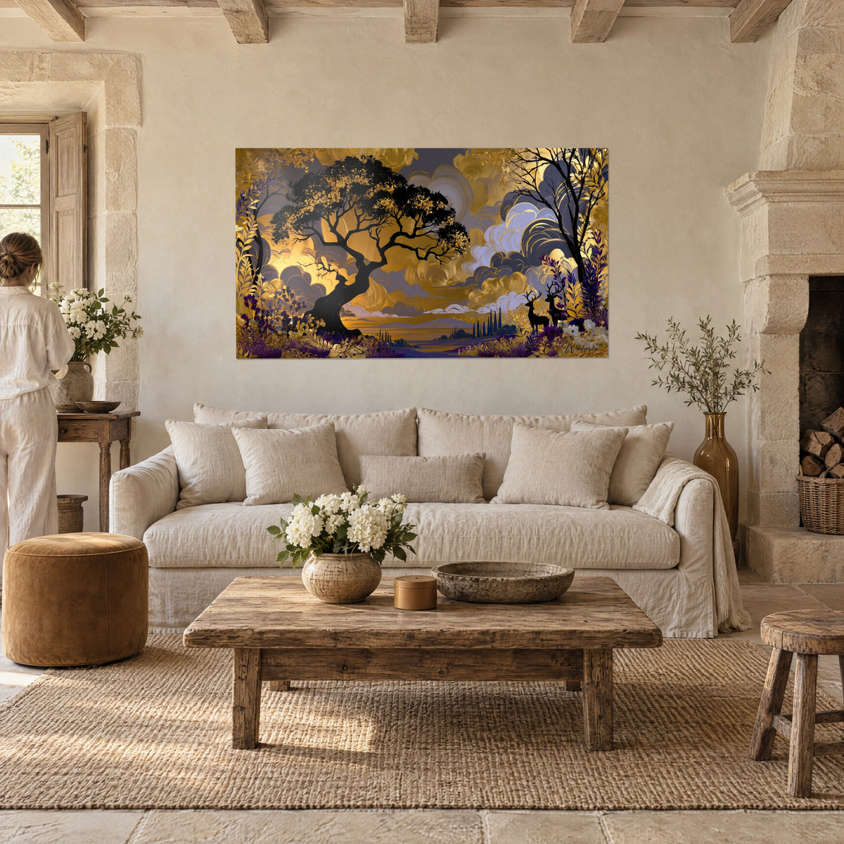 Wall art of sculptural black oak under a golden and amethyst sky, deer in shadow, above a sofa in a bright living room