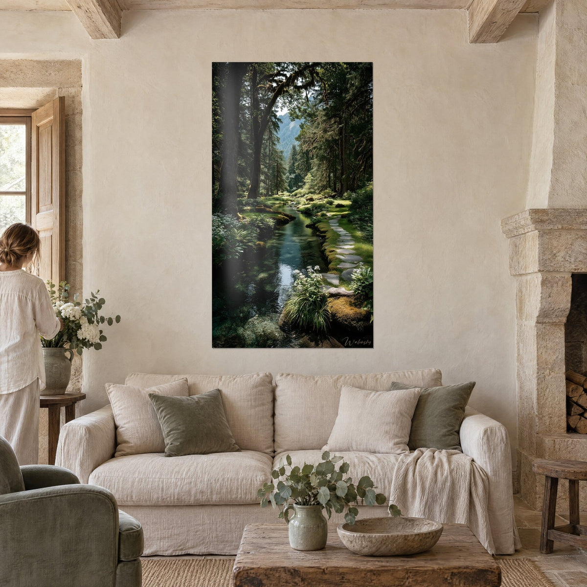Tableau ruisseau limpide serpentant sous de grands sapins moussus, vert émeraude et bleu acier, femme de dos, au-dessus d'un canapé dans un salon lumineux