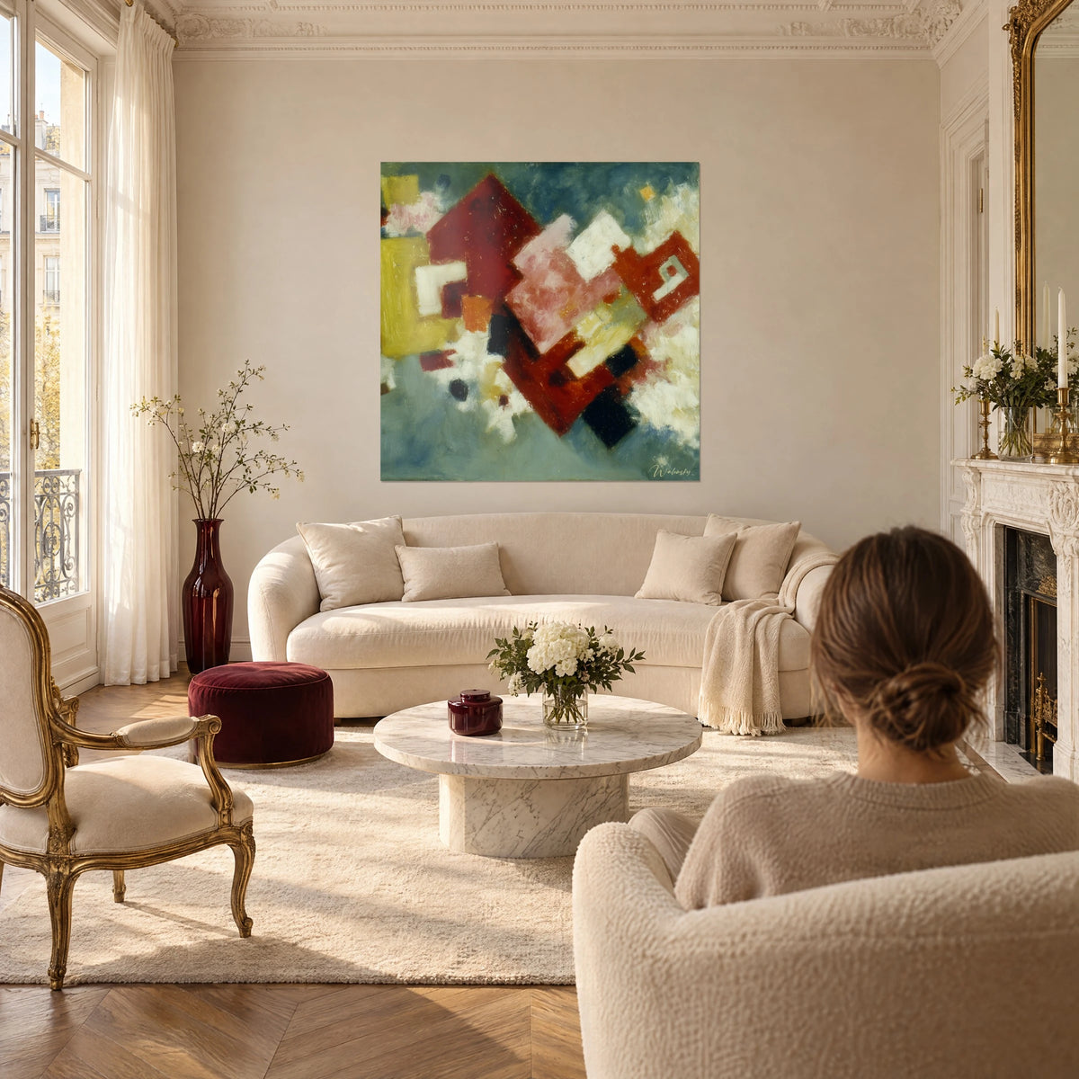 Wall art red and powder pink rhombuses on a blue-grey background, ochre touches, above a sofa in a bright living room