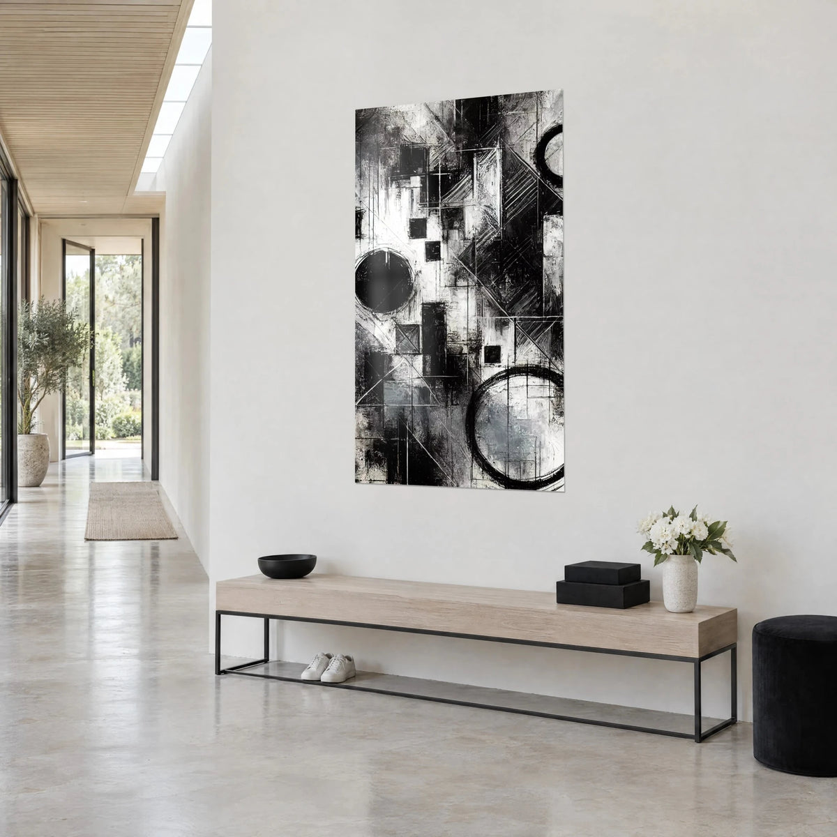 Tableau abstraction monochrome aux hachures croisées, gris argenté et noir profond, sur un mur blanc près d'une console en bois