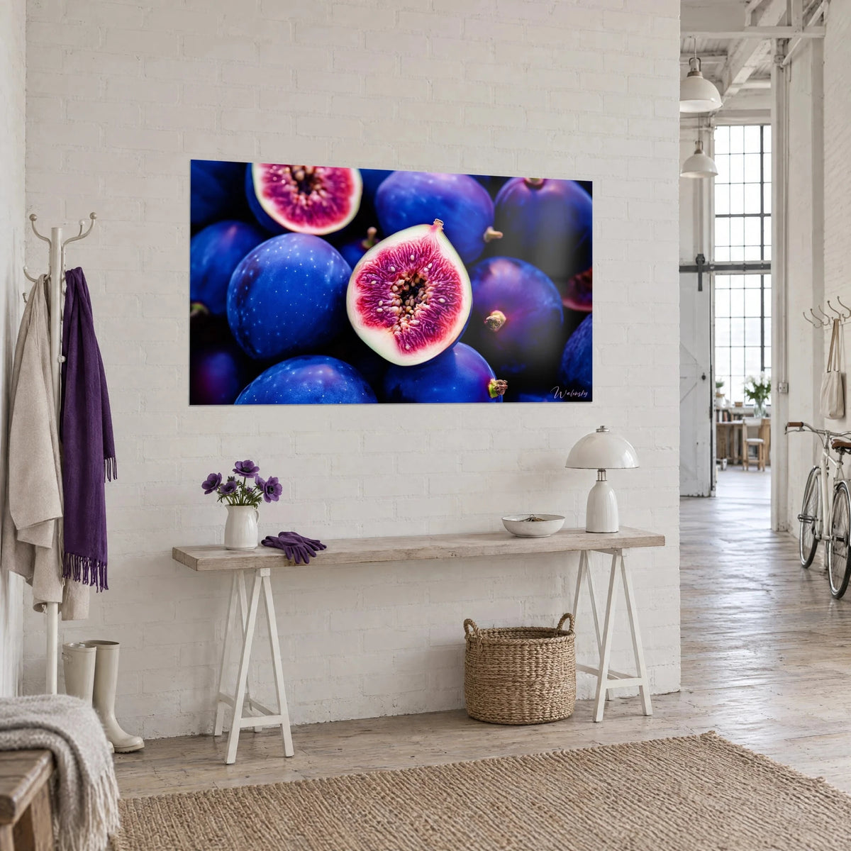 Wall art fruit cut in half revealing its golden seeds, midnight blue skin, white console, artist loft