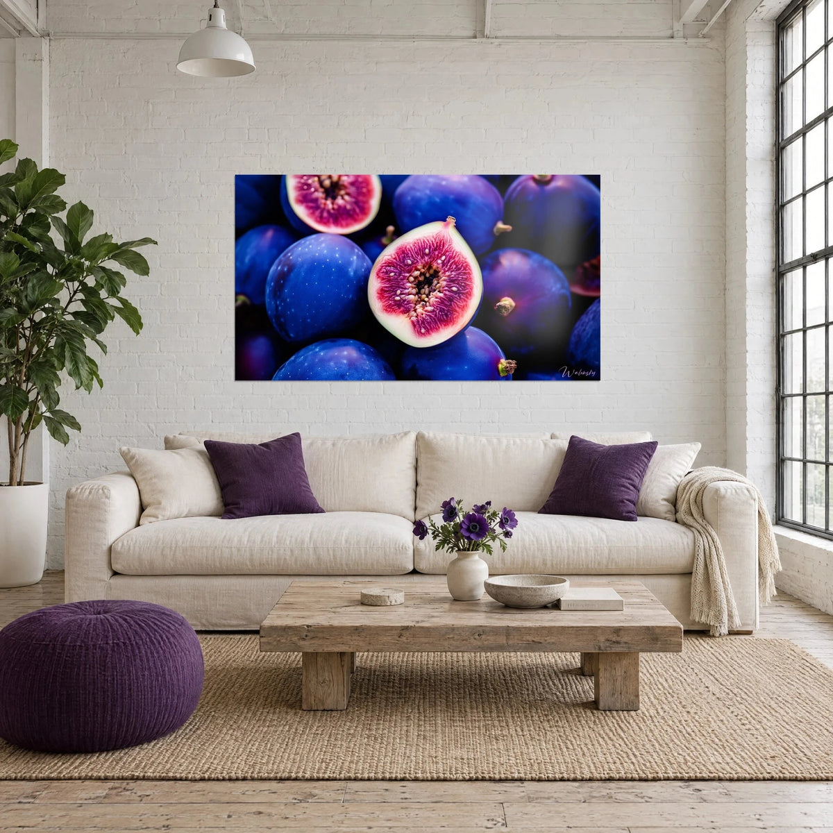 Wall art ripe purple figs, open fuchsia pink flesh, above a sofa in a bright living room