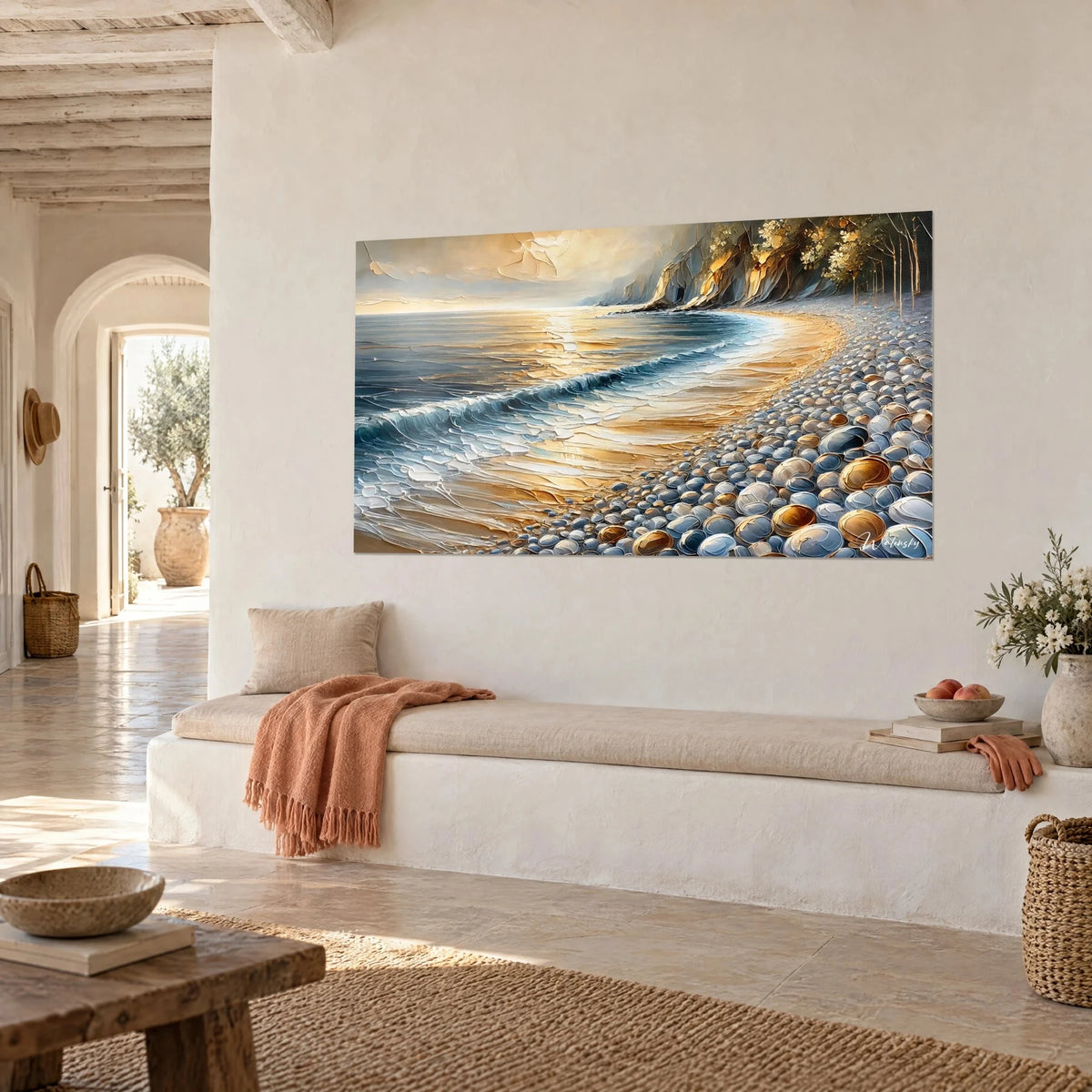 Wall art of beach at sunset in thick impasto, amber sand, white foam and grey pebbles, hung above a bench in pale stone