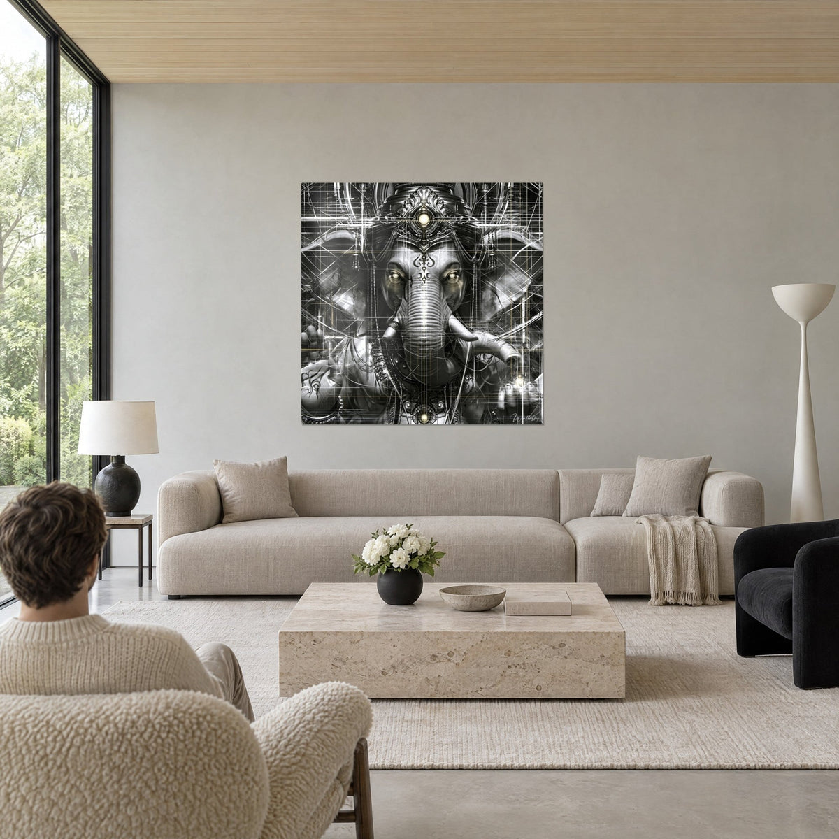 Wall art sacred elephant in grey and gold with a luminous gaze, white line grid, above a sofa in a bright living room
