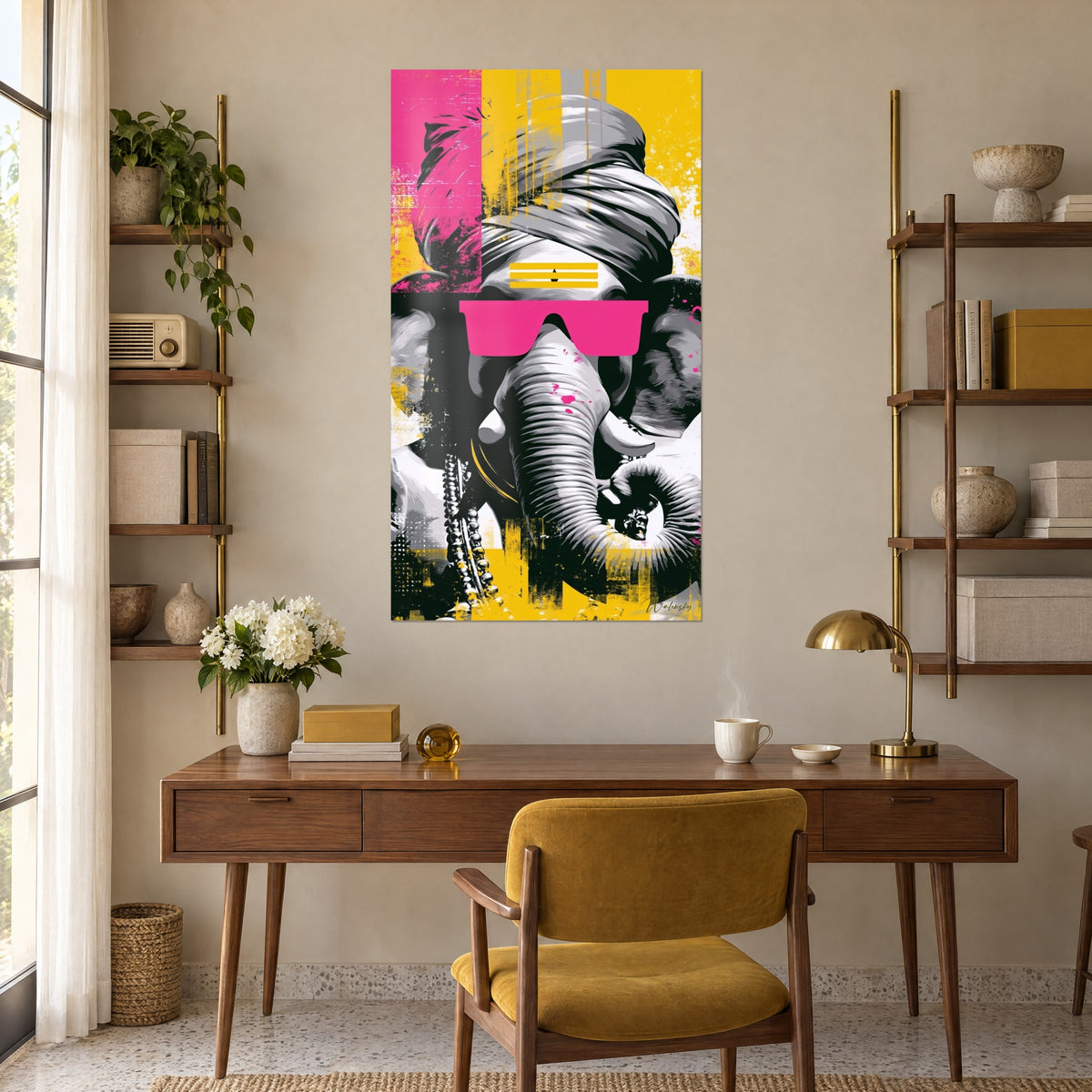 Wall art graphic Ganesh, coiled trunk and silver pearls, pink spots on yellow and black background, on the wall of a wooden desk