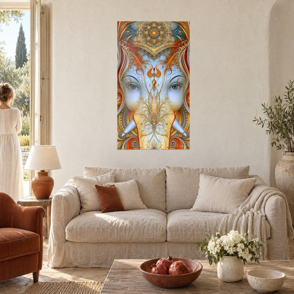 Wall art pale blue elephant with piercing eyes, golden and orange arabesques, woman seen from behind, above a sofa in a bright living room