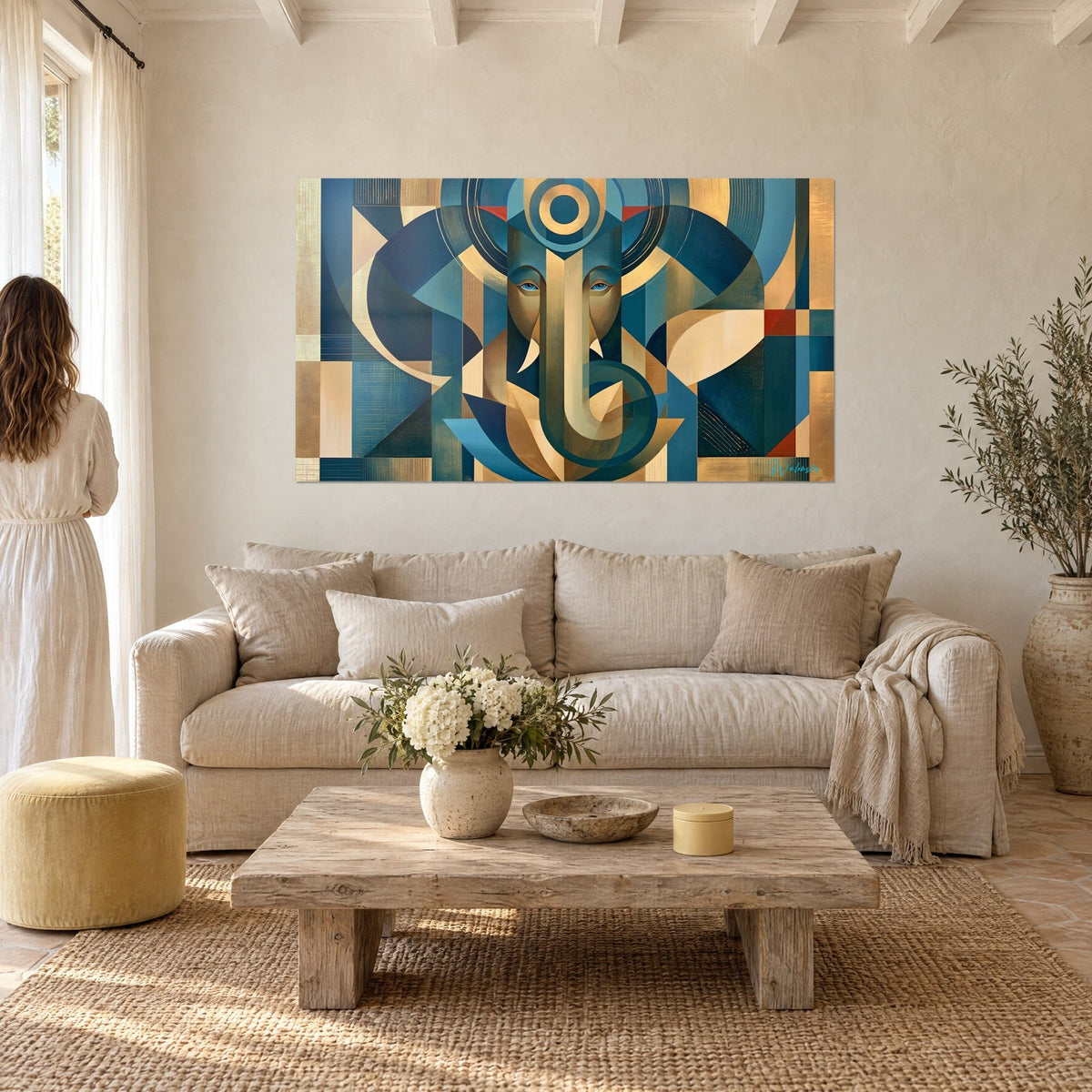 Wall art stylized Ganesh elephant in navy blue and gold flat planes, blue eyes, curved trunk, above a sofa in a bright living room