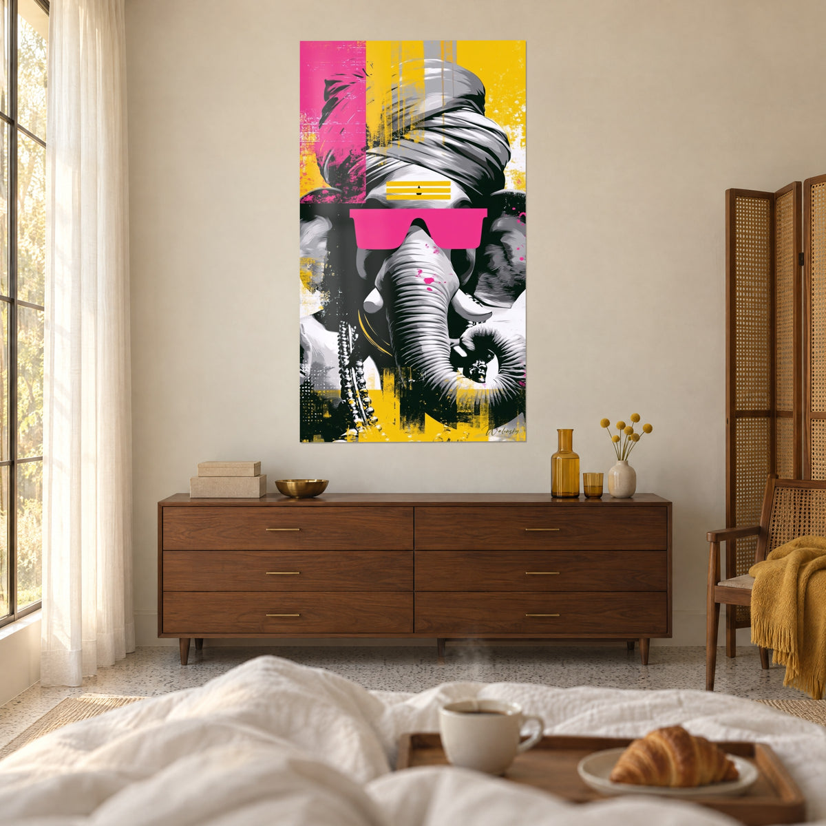 Wall art elephant wearing a grey turban, yellow headband across the forehead, vivid pink glasses, above a bed in a light bedroom
