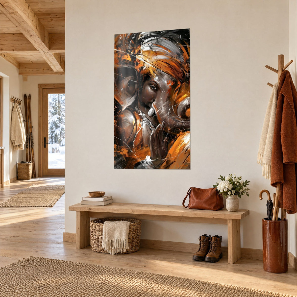 Wall art elephant god with brown and bright orange features, raised hand, hung on a white wall next to a light wood bench