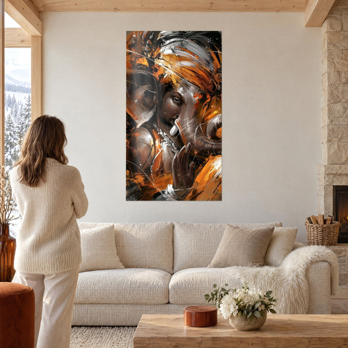 Wall art Ganesh with grey trunk and orange turban, brown brushstrokes, woman seen from behind above a sofa in a bright living room