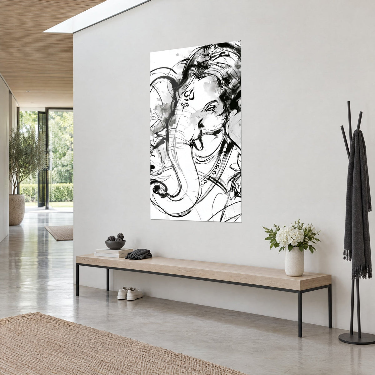 Wall art Ganesh with a round pearl necklace, black lines and grey wash on white, three-quarter view in a bright hallway