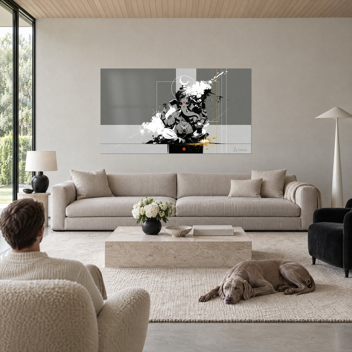 Gemälde Ganesha mit vier Armen, schwarze und weiße Spritzer auf grauem Grund, Paar von hinten, über einem Sofa in einem hellen Wohnzimmer