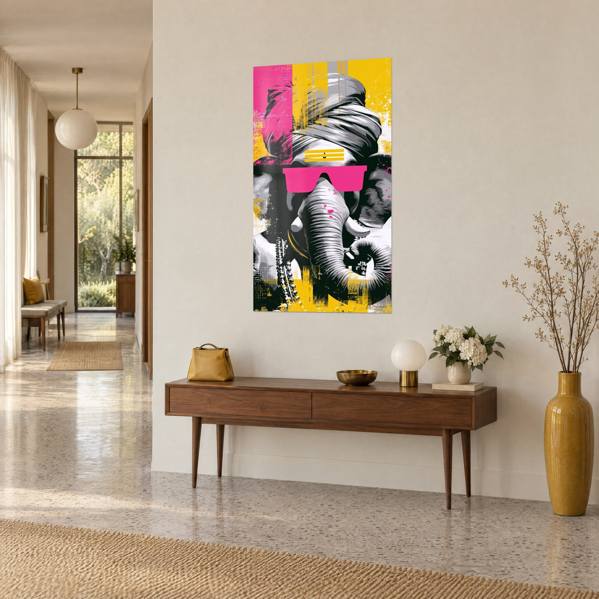 Wall art deity with a striped trunk and a silver pearl necklace, pink and yellow splashes, on a wooden console, three-quarter view