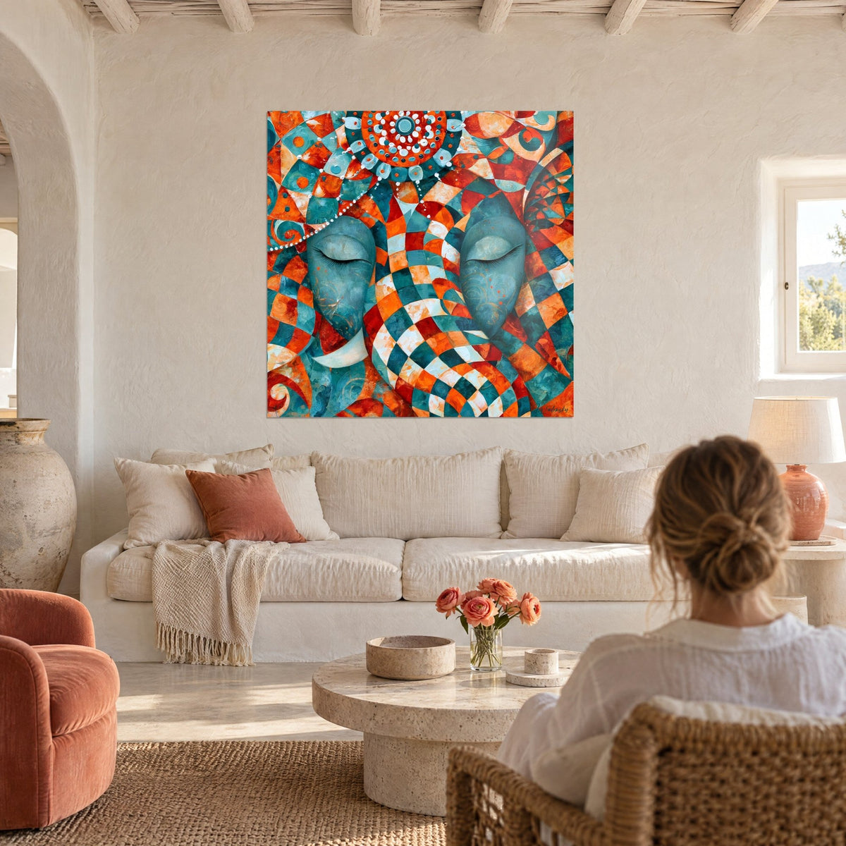 Wall art elephant-headed deity with closed eyes, teal and orange checkerboard, dotted mandala, above a sofa in a bright living room