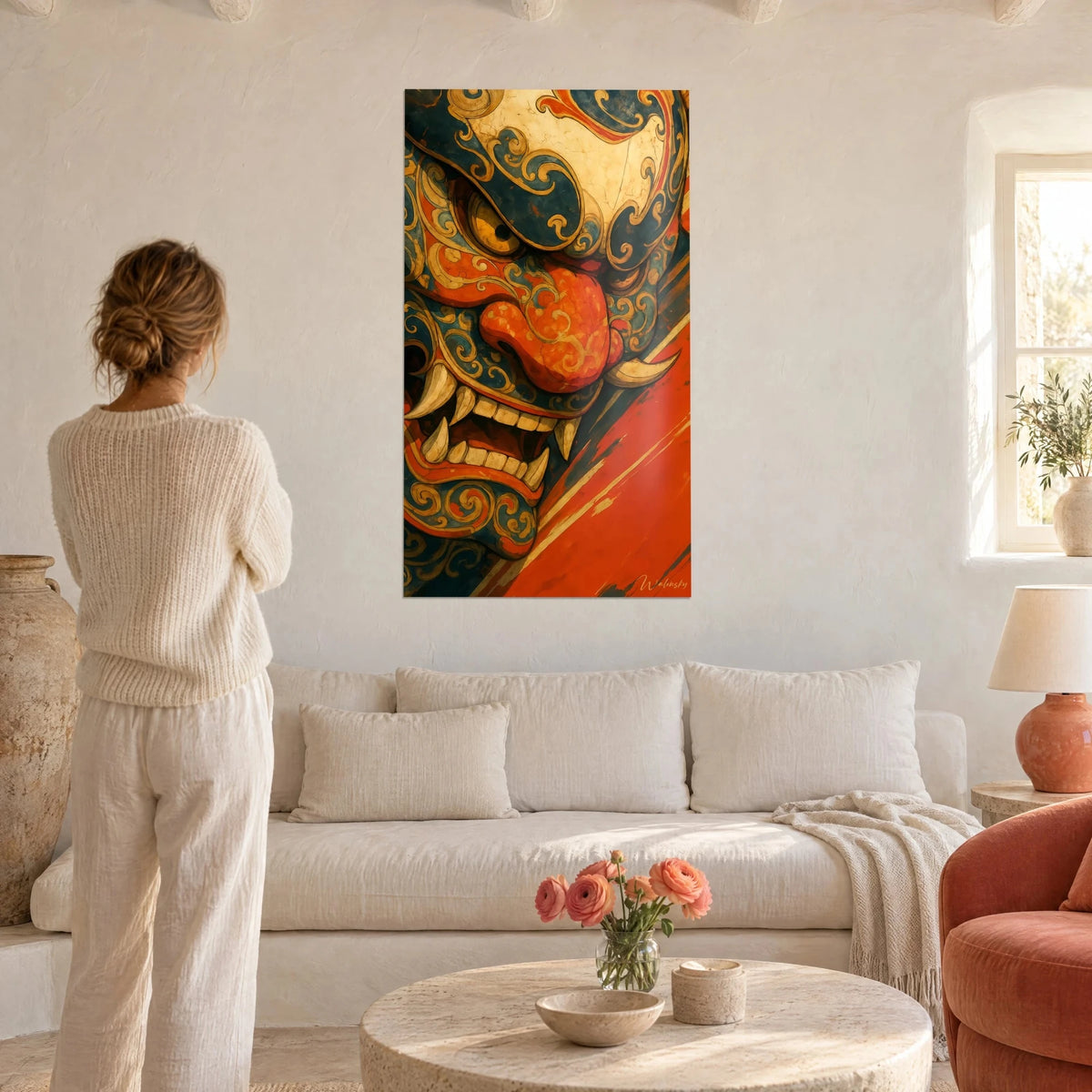 Wall art oni demon with ivory fangs, midnight-blue face and orange tongue, hung above a sofa in a bright living room