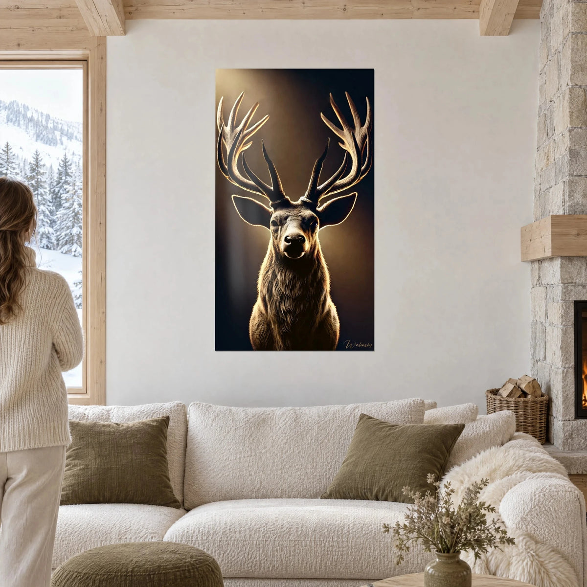 Wall art of a majestic stag with ivory antlers backlit in gold on a dark brown background, above a sofa in a bright living room
