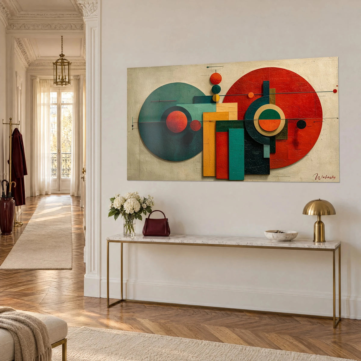 Wall art with an abstract composition of vermilion red and pine green discs and yellow rectangles on a white entrance wall