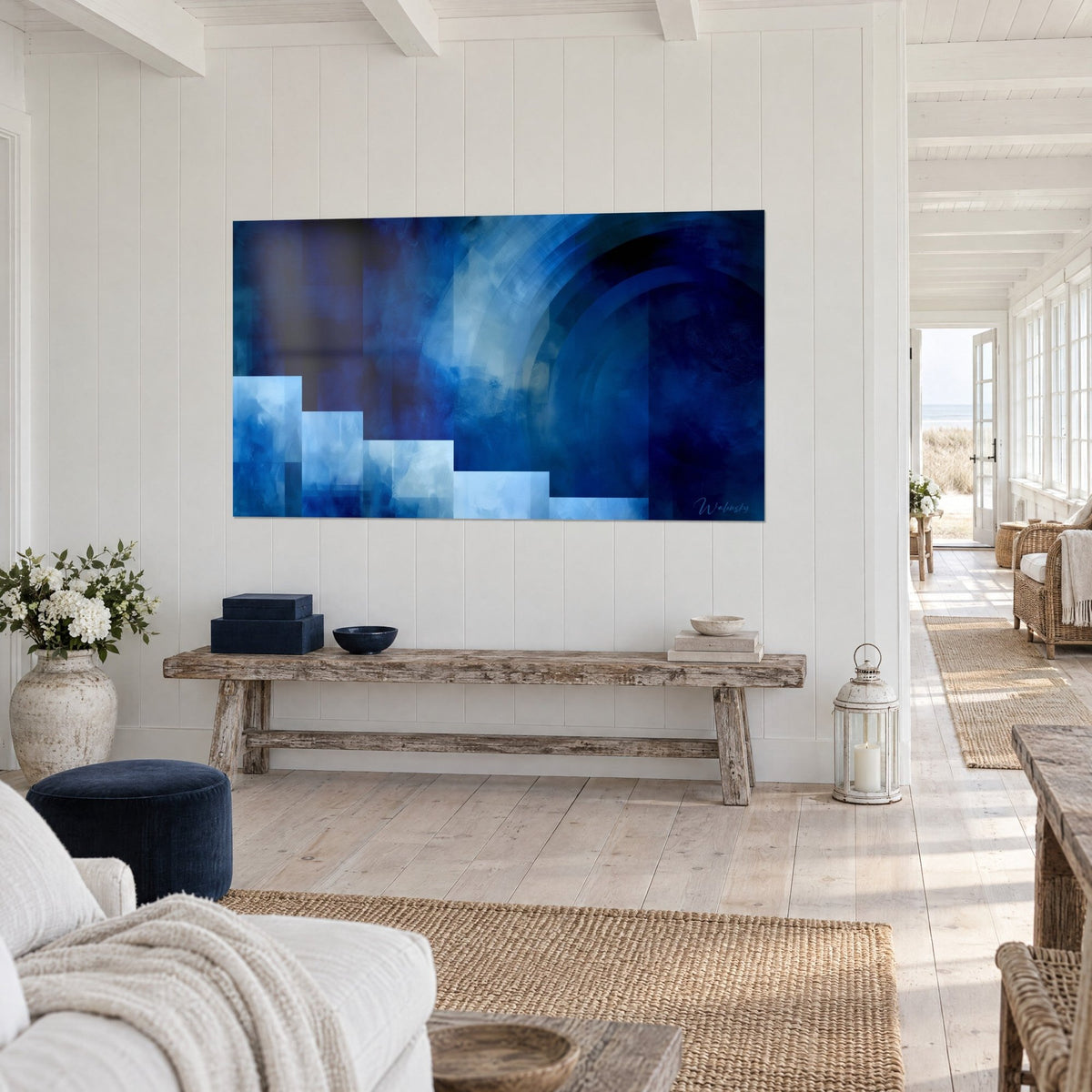Wall art abstract seascape in navy and cobalt, pale steps at bottom left, three-quarter view on a white panelled wall