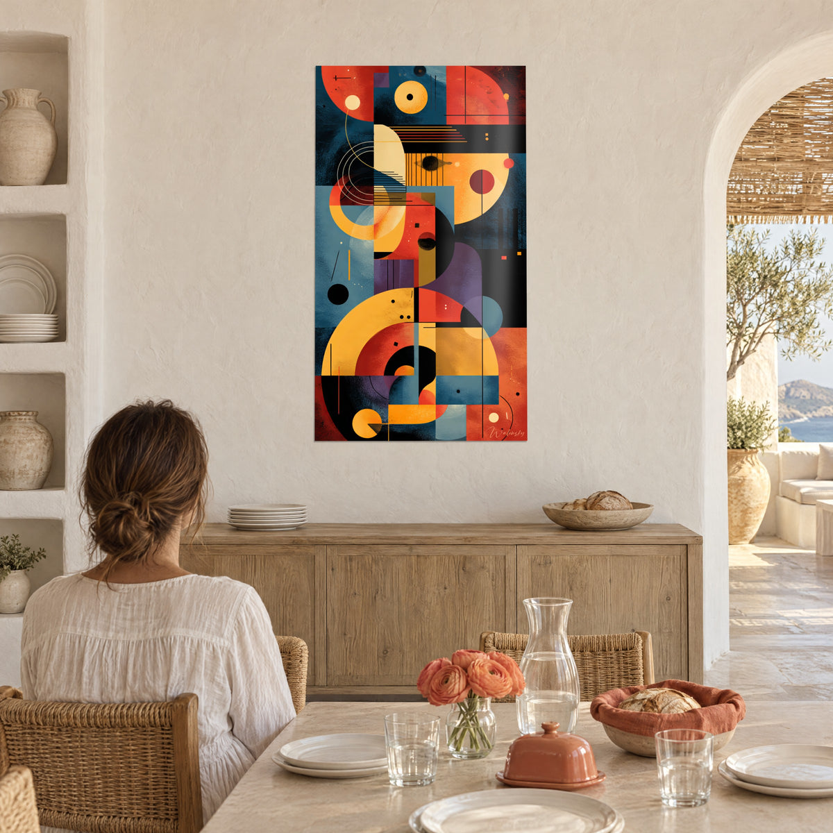 Cuadro Mosaico abstracto de círculos amarillos, rojos y azul acero, mujer de espaldas sentada a la mesa en un comedor luminoso