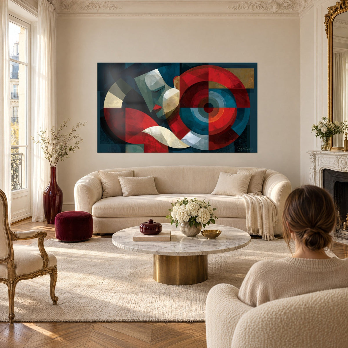Wall art Cubist profile with large red and navy blue discs, two people seen from behind above a sofa in a bright living room