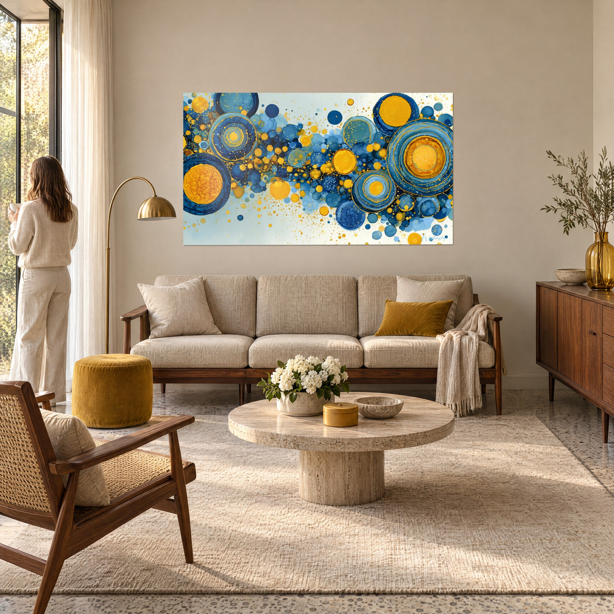 Wall art with blue and gold spheres in concentric circles, large ochre and navy discs, above a sofa in a bright living room