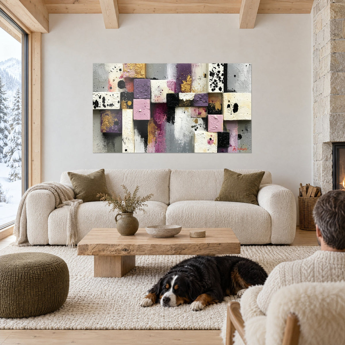 Wall art mosaic of mauve, powder pink and cream blocks, gold flecks and black smudges, above a sofa in a bright living room