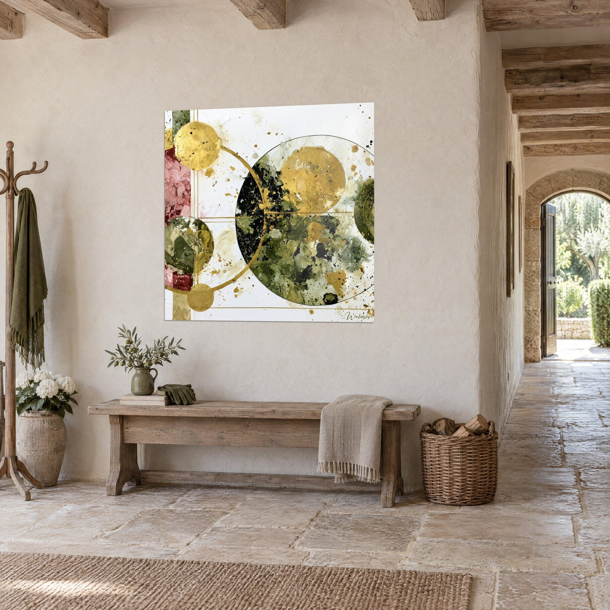 Abstract wall art of gold and khaki green discs crossed by a fine line, hung above a wooden bench in a stone hallway