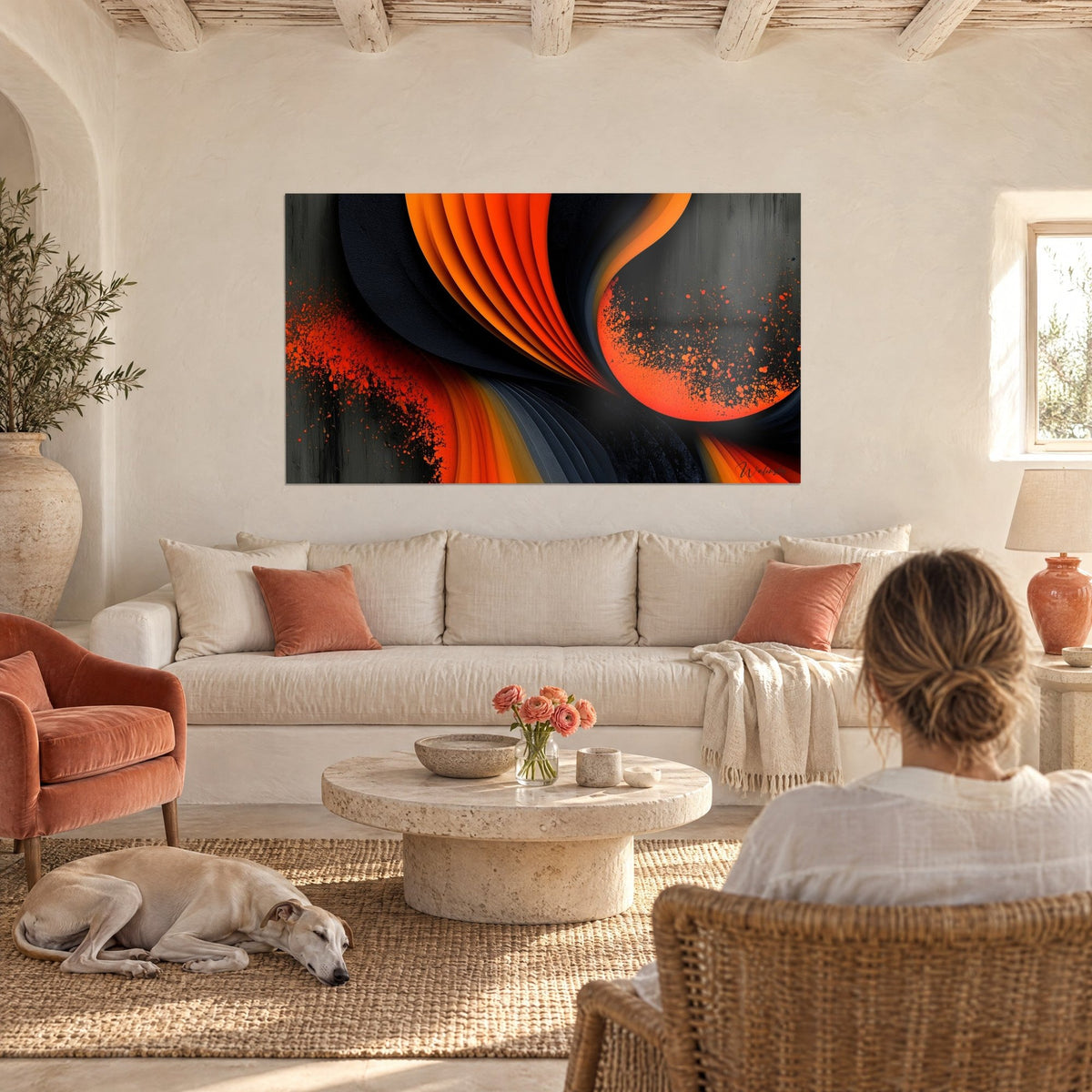 Wall art with orange and charcoal slats in a spiral, red splashes, woman from behind and a greyhound, above a sofa in a bright living room