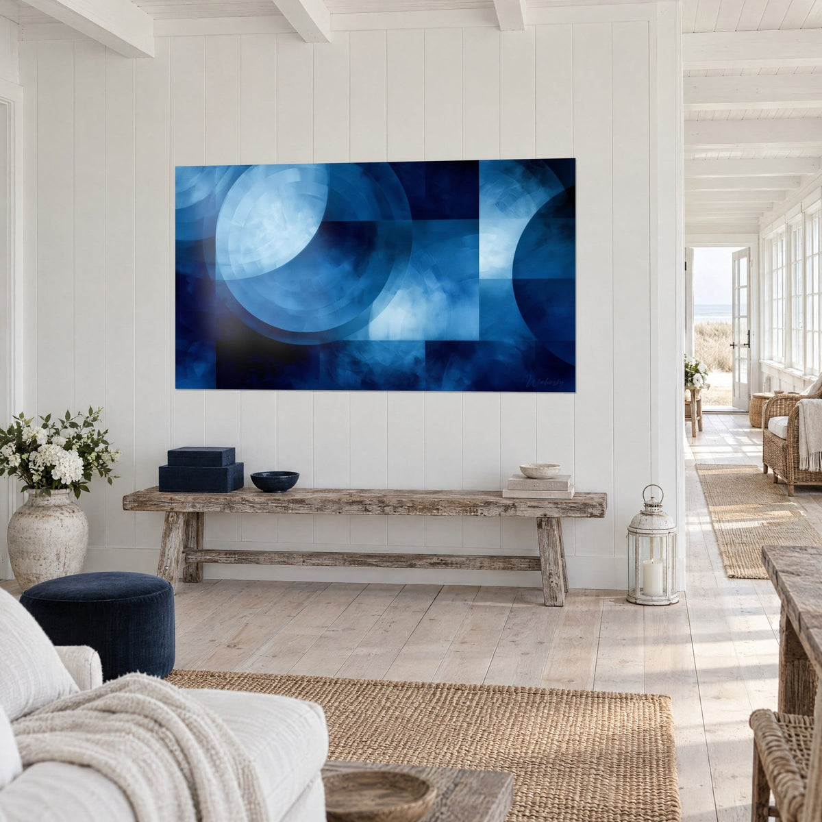 Wall art nocturnal eclipse in bold royal blue and icy white, hung above a raw wood bench, seaside house