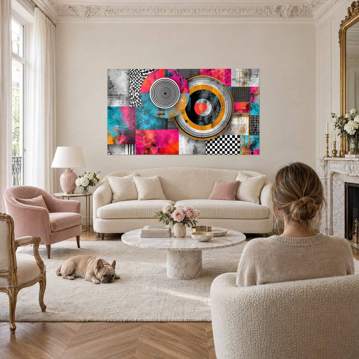 Wall art with concentric discs in fuchsia and turquoise, black and white checkerboard, bulldog and woman from behind above a sofa in a bright living room