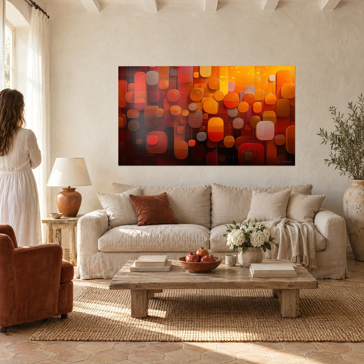 Wall art mosaic of translucent rounded shapes, fiery orange and carmine red, above a sofa in a bright living room