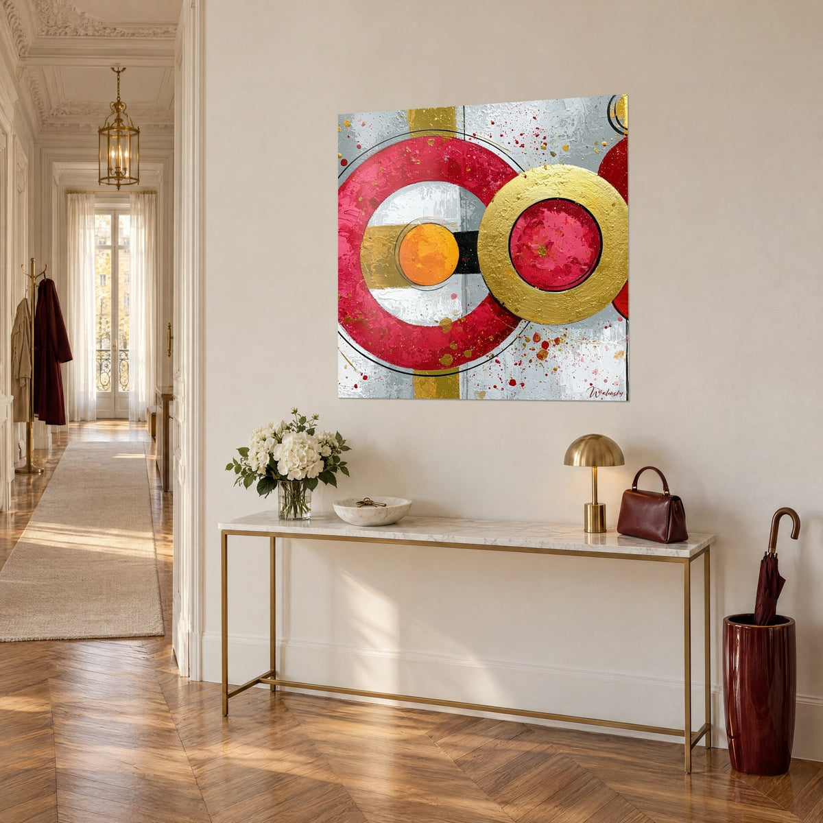Cuadro Círculos concéntricos carmesí, disco naranja y anillo dorado texturizado, vista de tres cuartos, consola blanca en un pasillo haussmanniano