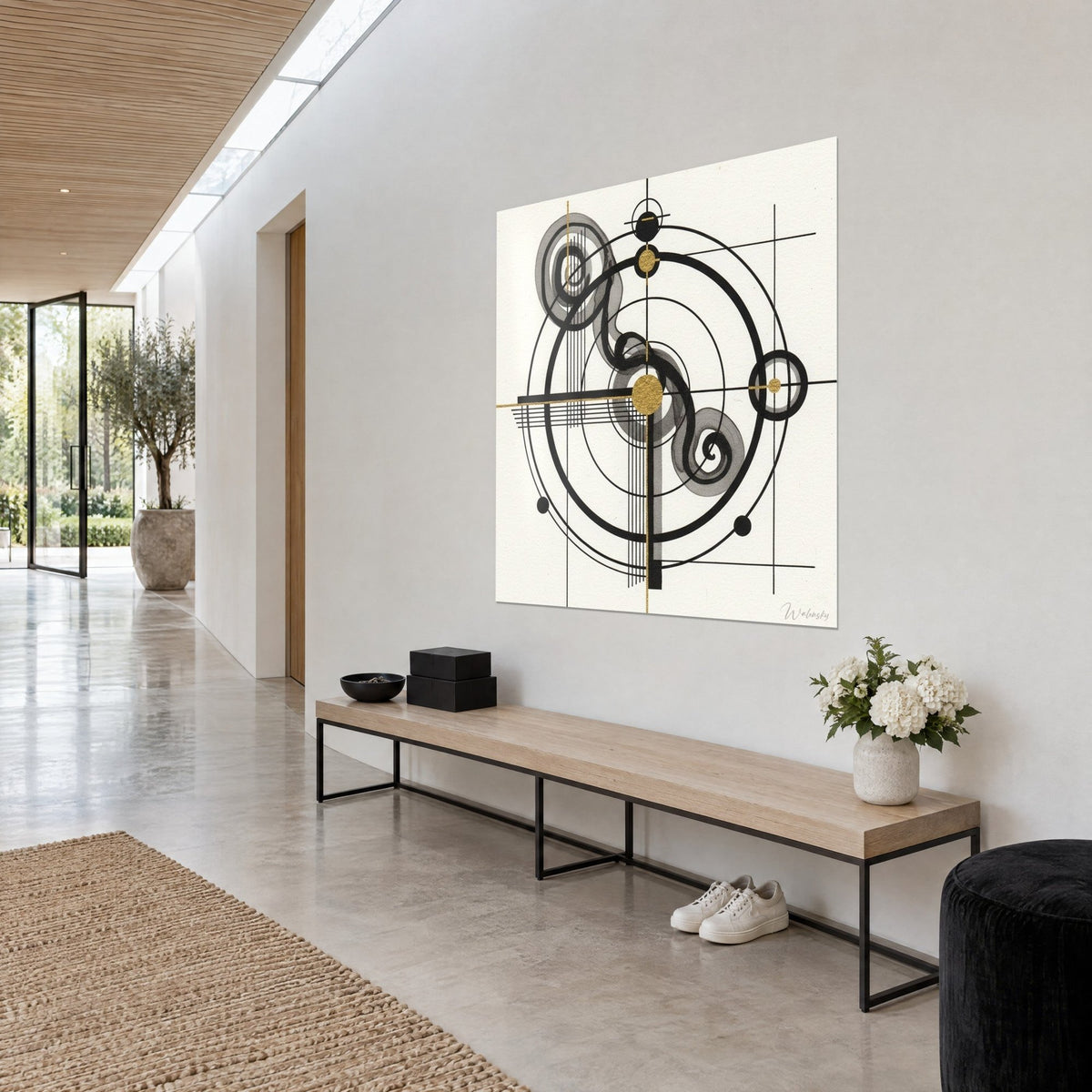 Wall art of celestial mechanics with black ink rings, grey spirals and a gold disc at the centre, three-quarter view on a white hallway wall