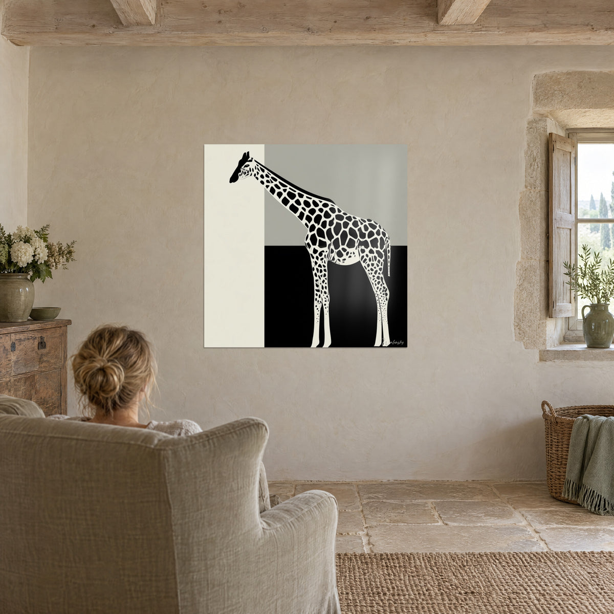Wall art African animal in black and cream contrast, grey and ivory tones, in a stone living room with a linen armchair