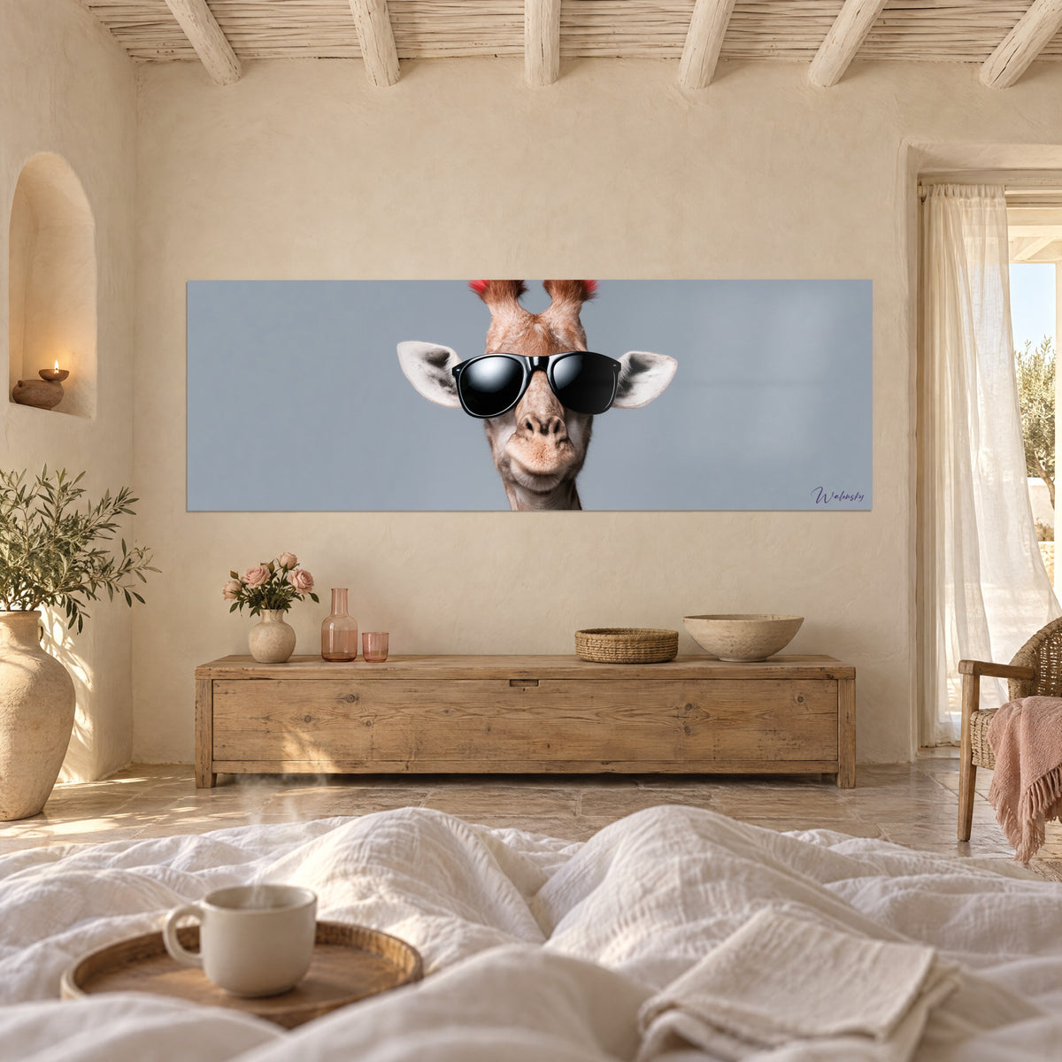 Tableau girafe branchée aux lunettes noires, pelage beige et fond gris-bleu, au-dessus d'un lit dans une chambre claire