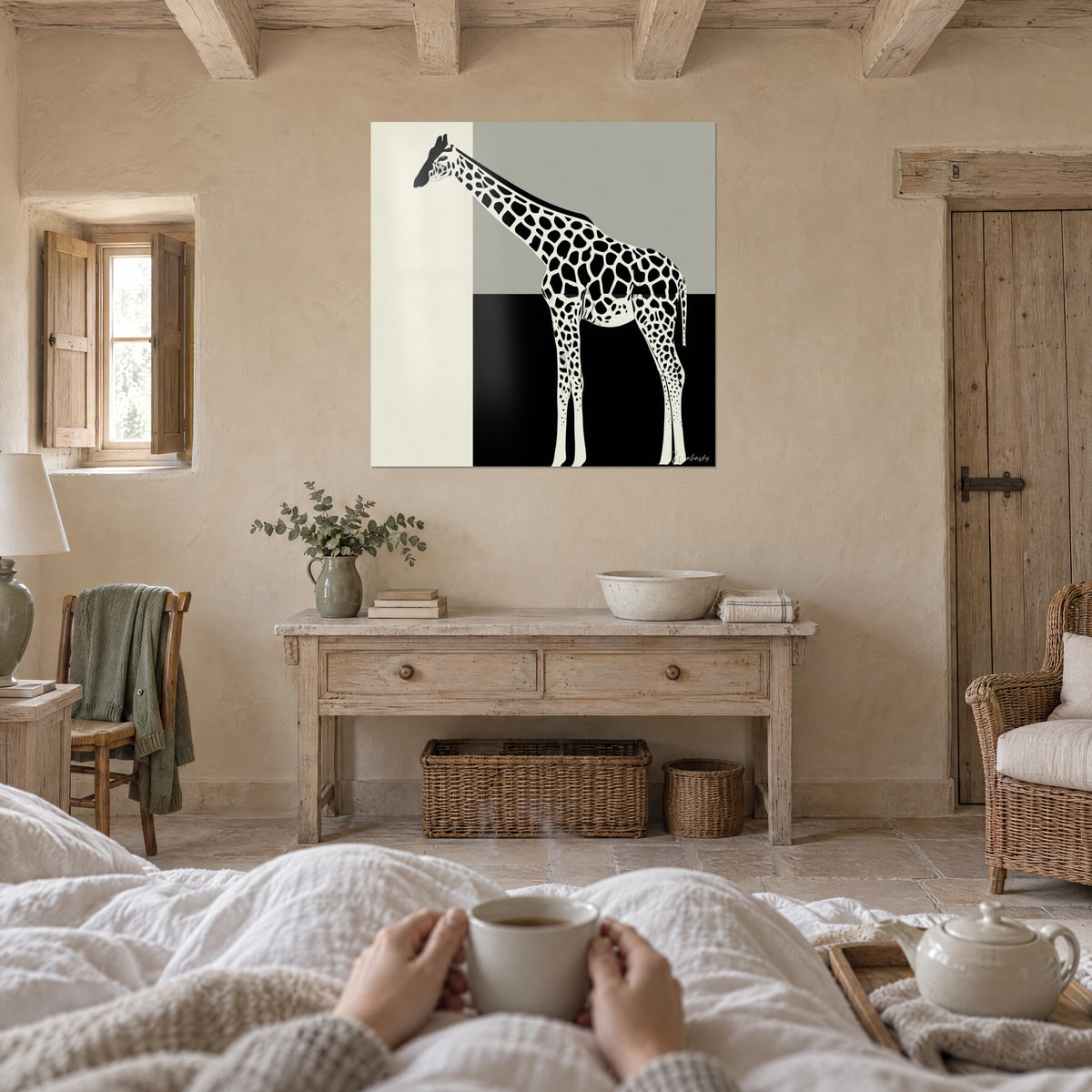 Wall art graphic giraffe, neck leaning left, black spots on cream and grey, above a bed in a light bedroom