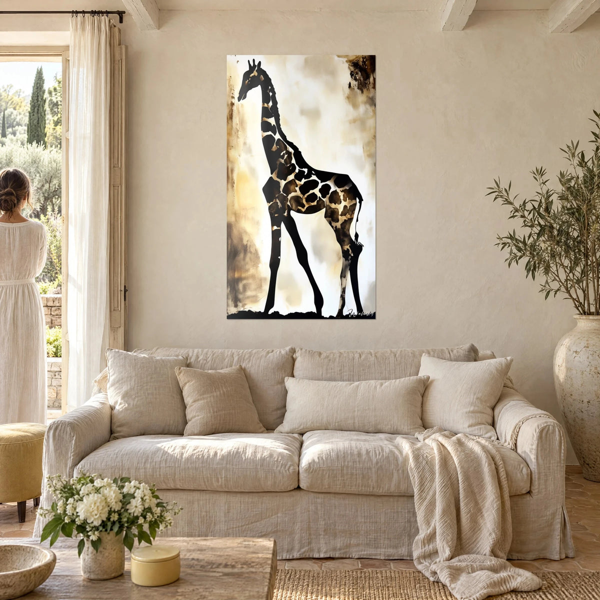 Wall art giraffe in black silhouette with brown spots on ochre and cream white background, above a sofa in a bright living room